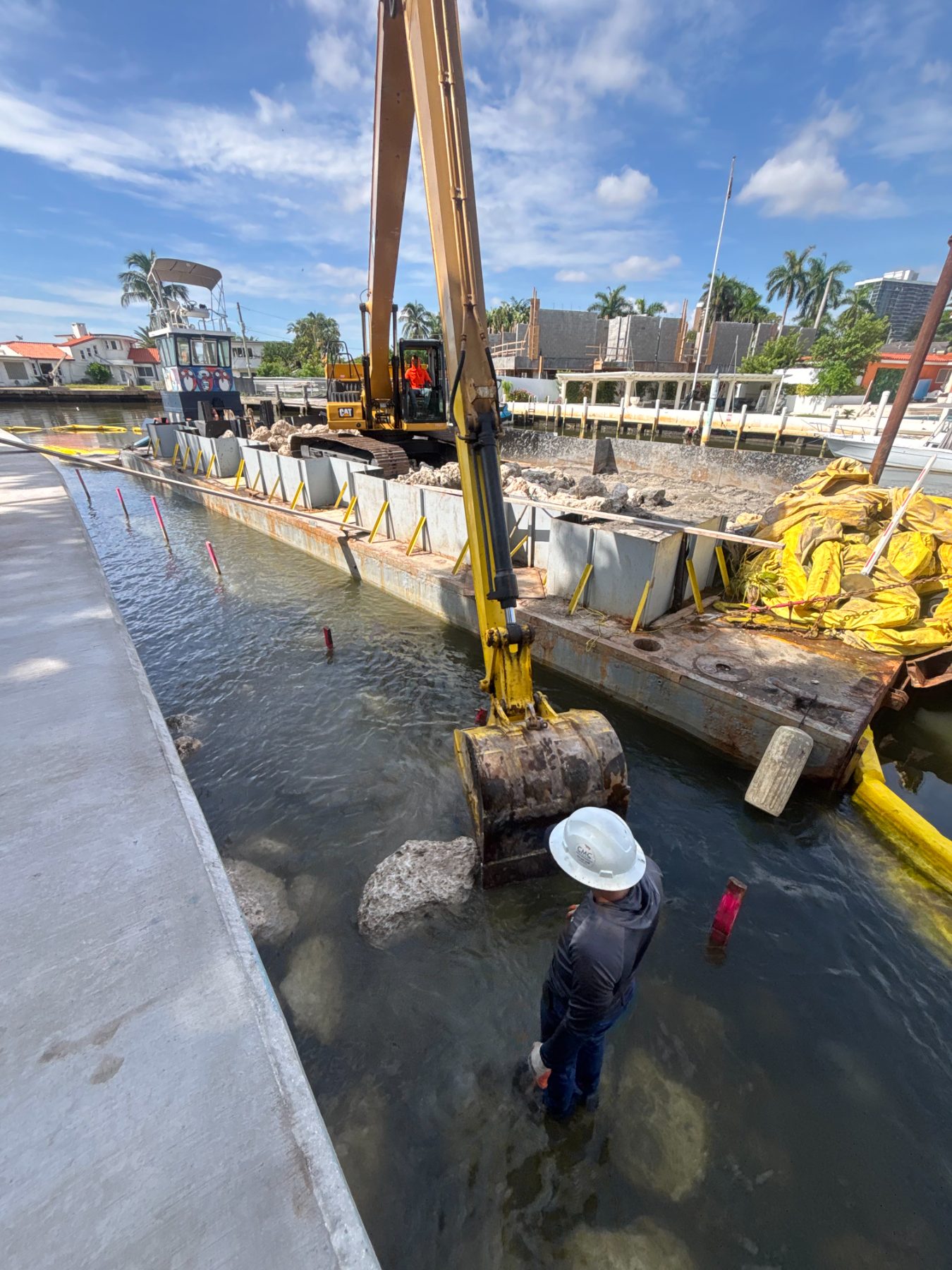 Turbidity curtain deployed around an active dredge site in a Miami canal