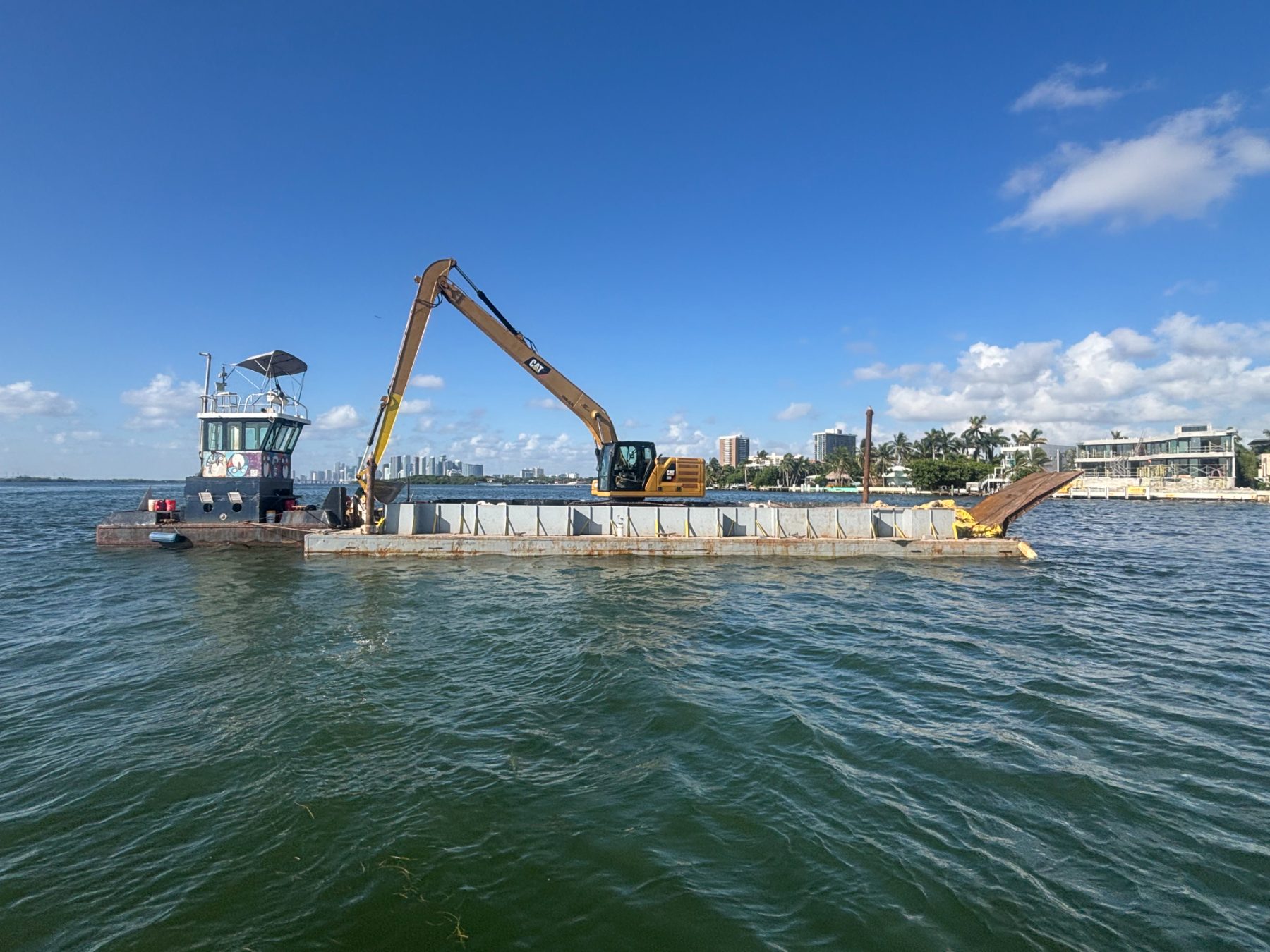 Spud barge and long-reach excavator dredging on Biscayne Bay