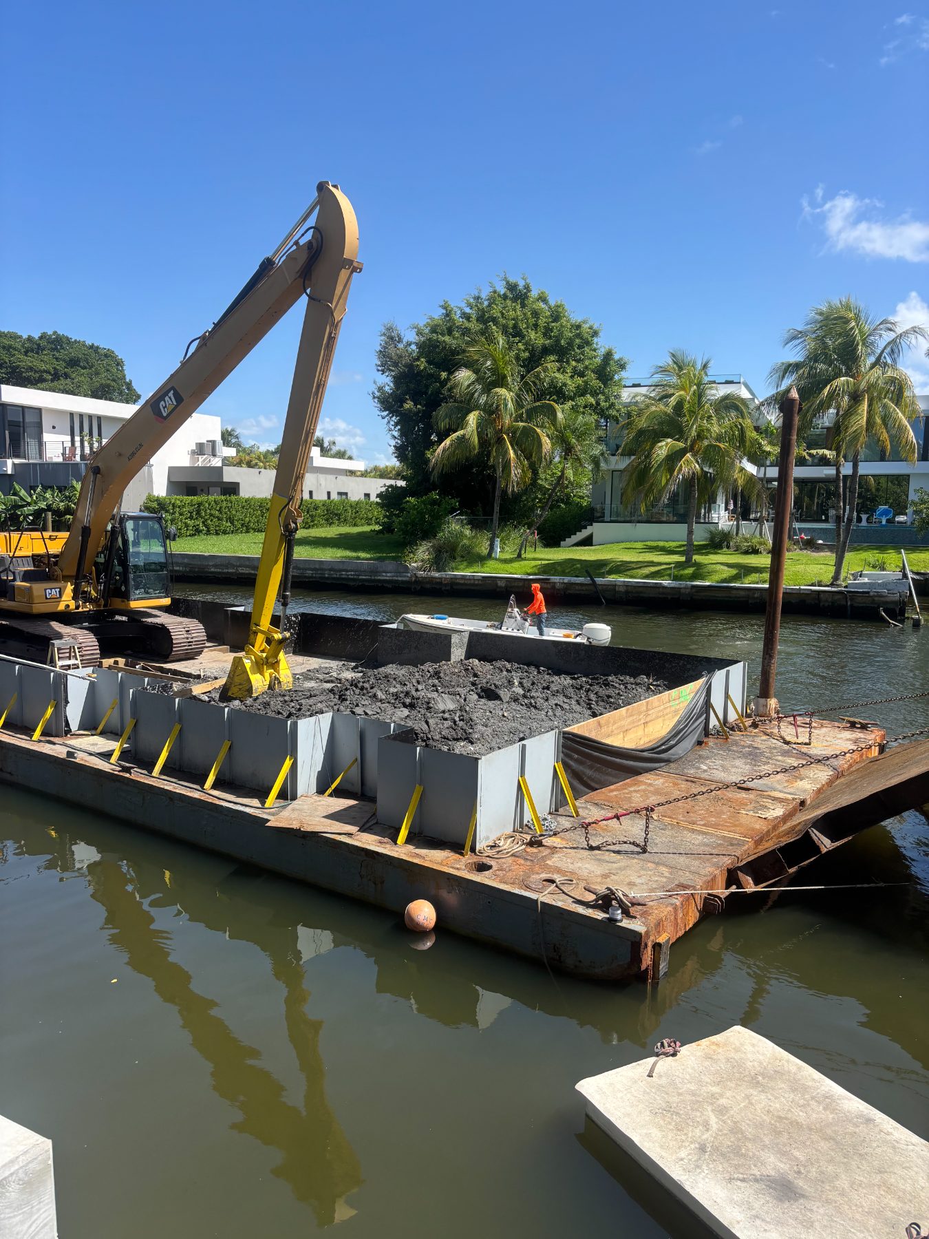 Marine demolition — old dock structure being removed from the water