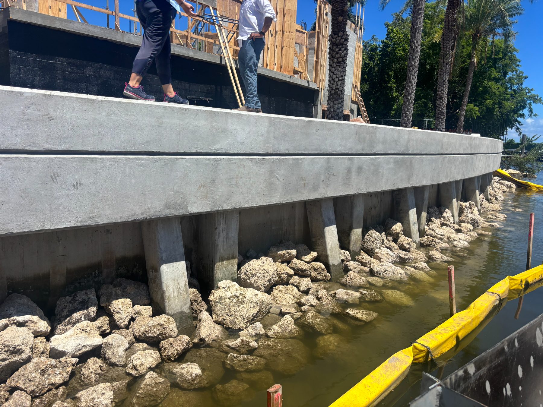 Completed concrete seawall with riprap toe protection